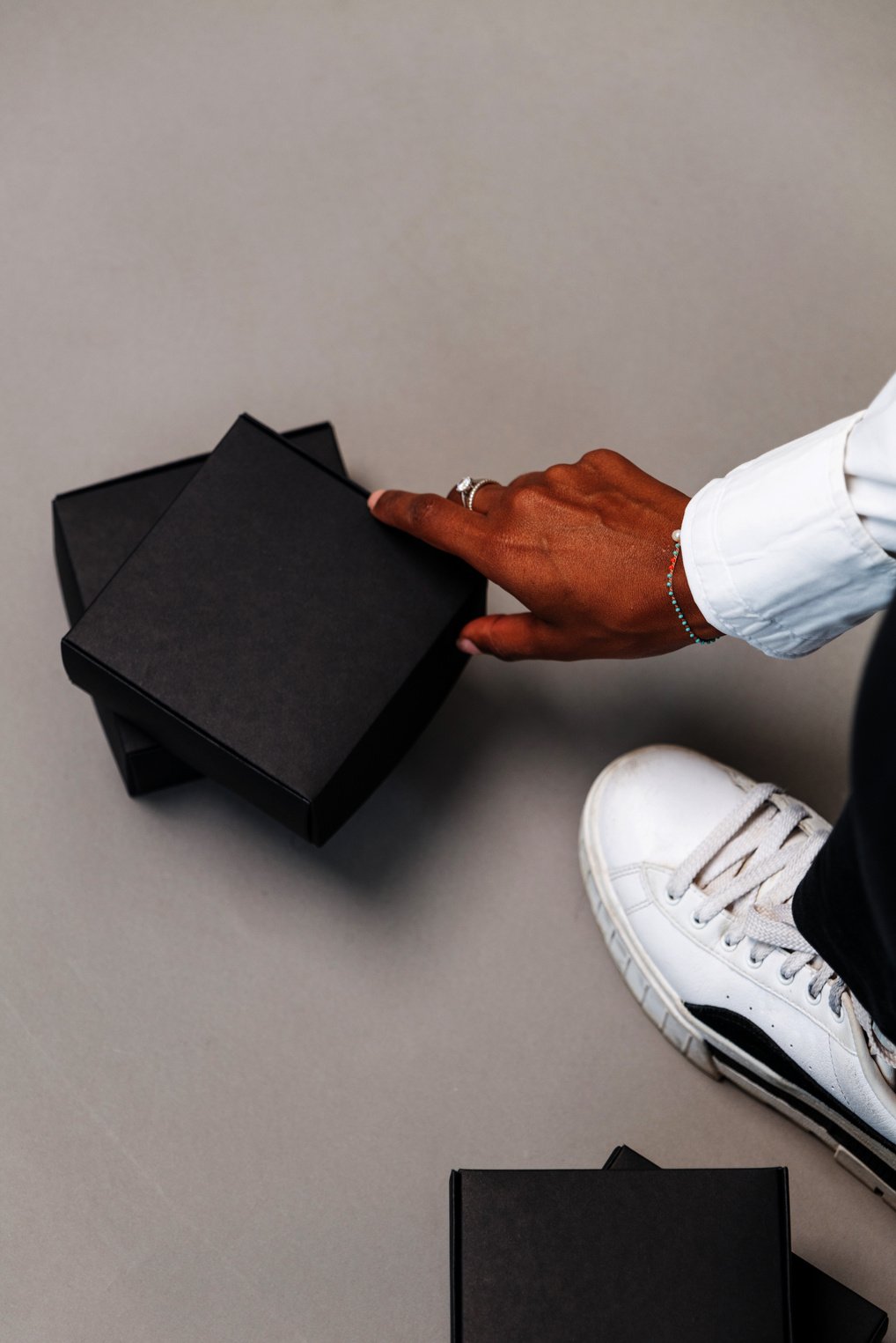 Person's Hand Touching a Black Box